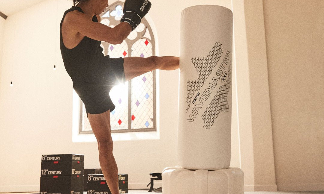Punching Bags - Century Martial Arts, man kicking century ghost wavemaster