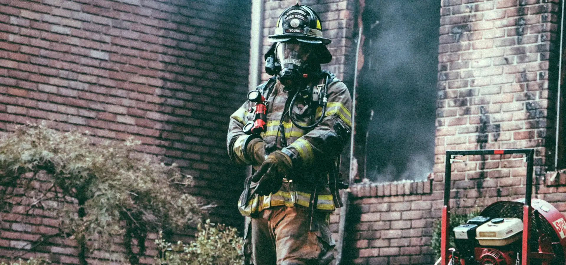 firemen outside of burnt building