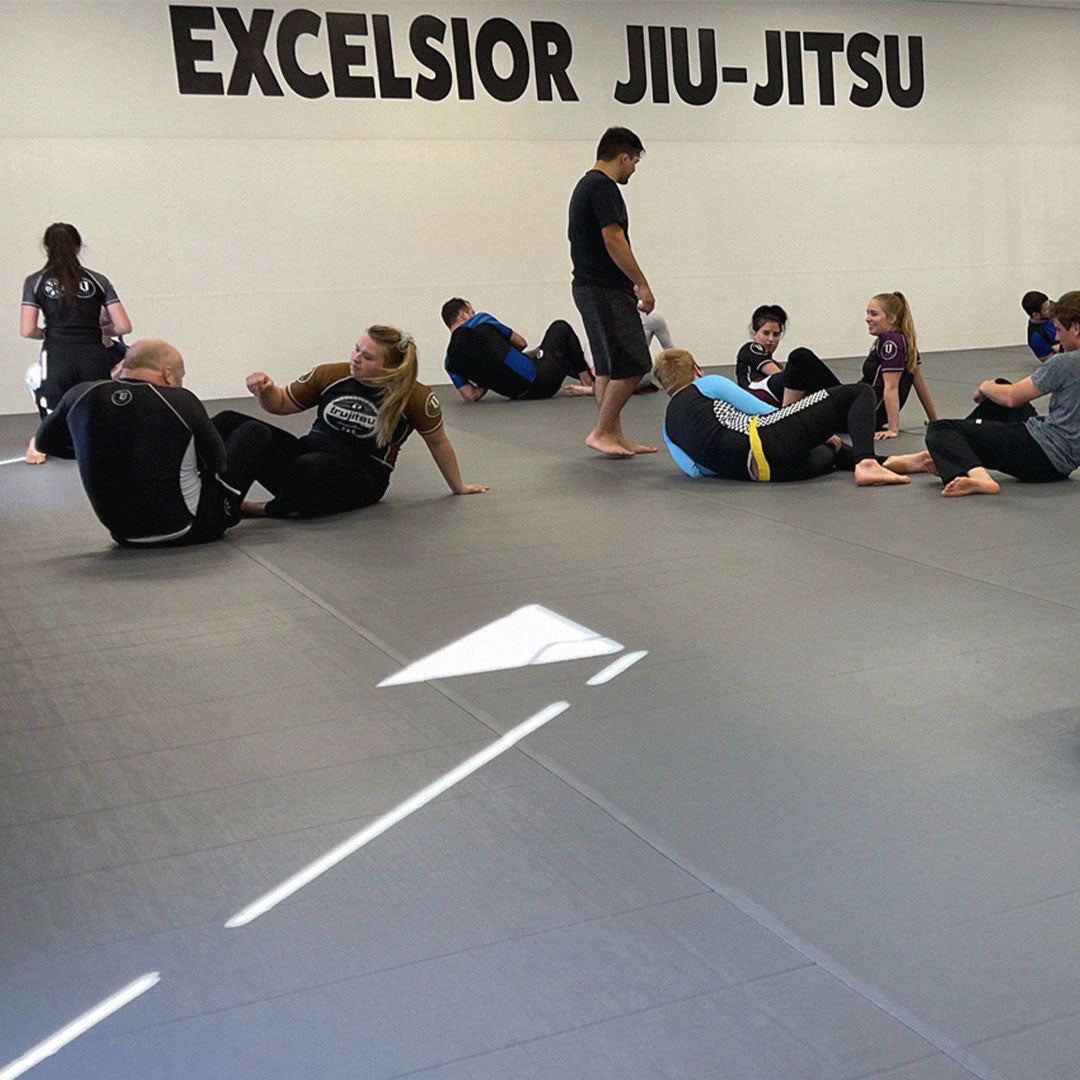 Excelsior Jiu-Jitsu students training on mats