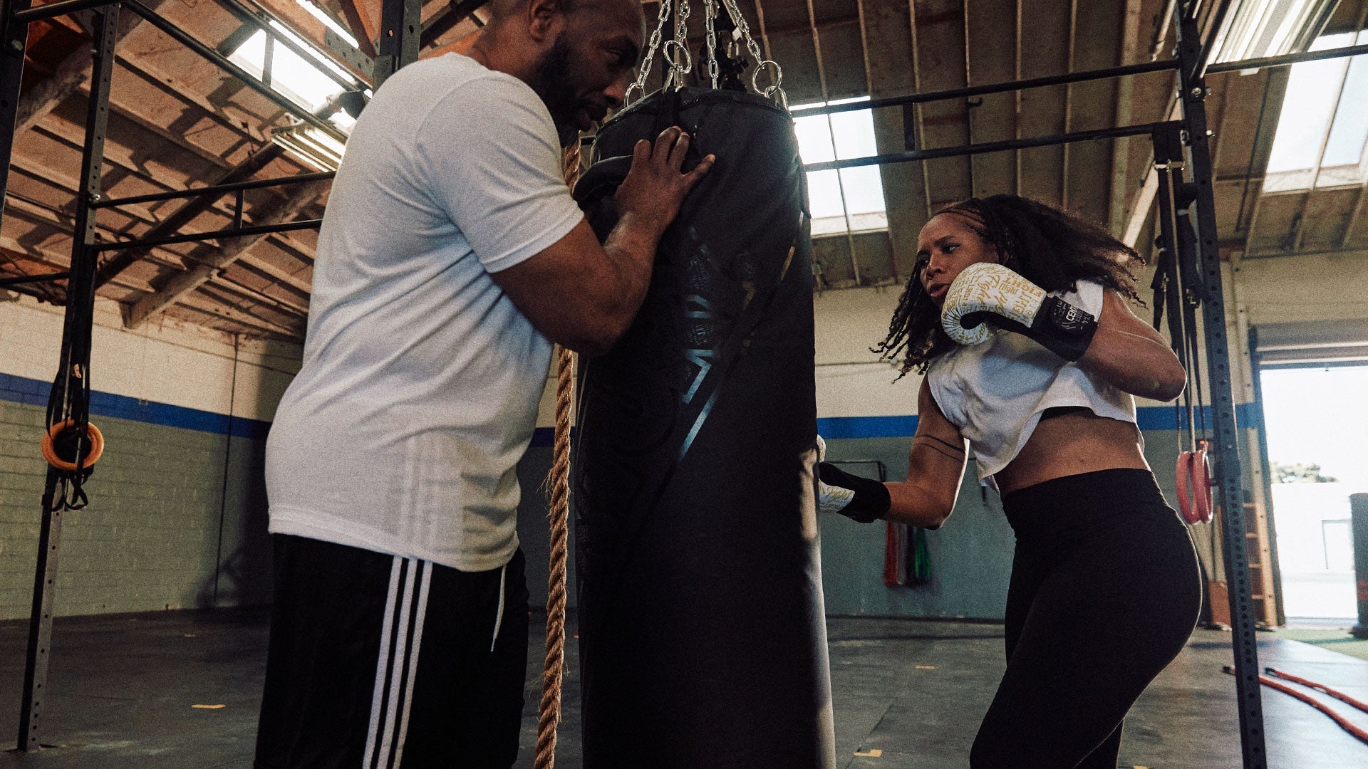 Hanging Bags - Century Martial Arts, woman punching bag with gloves