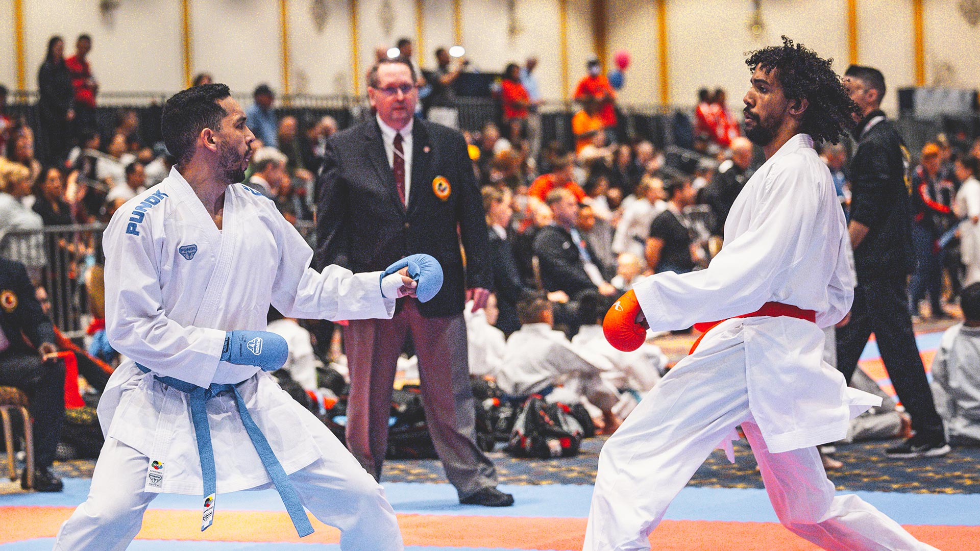 two men sparring in century punok gloves, belts and unifomrs