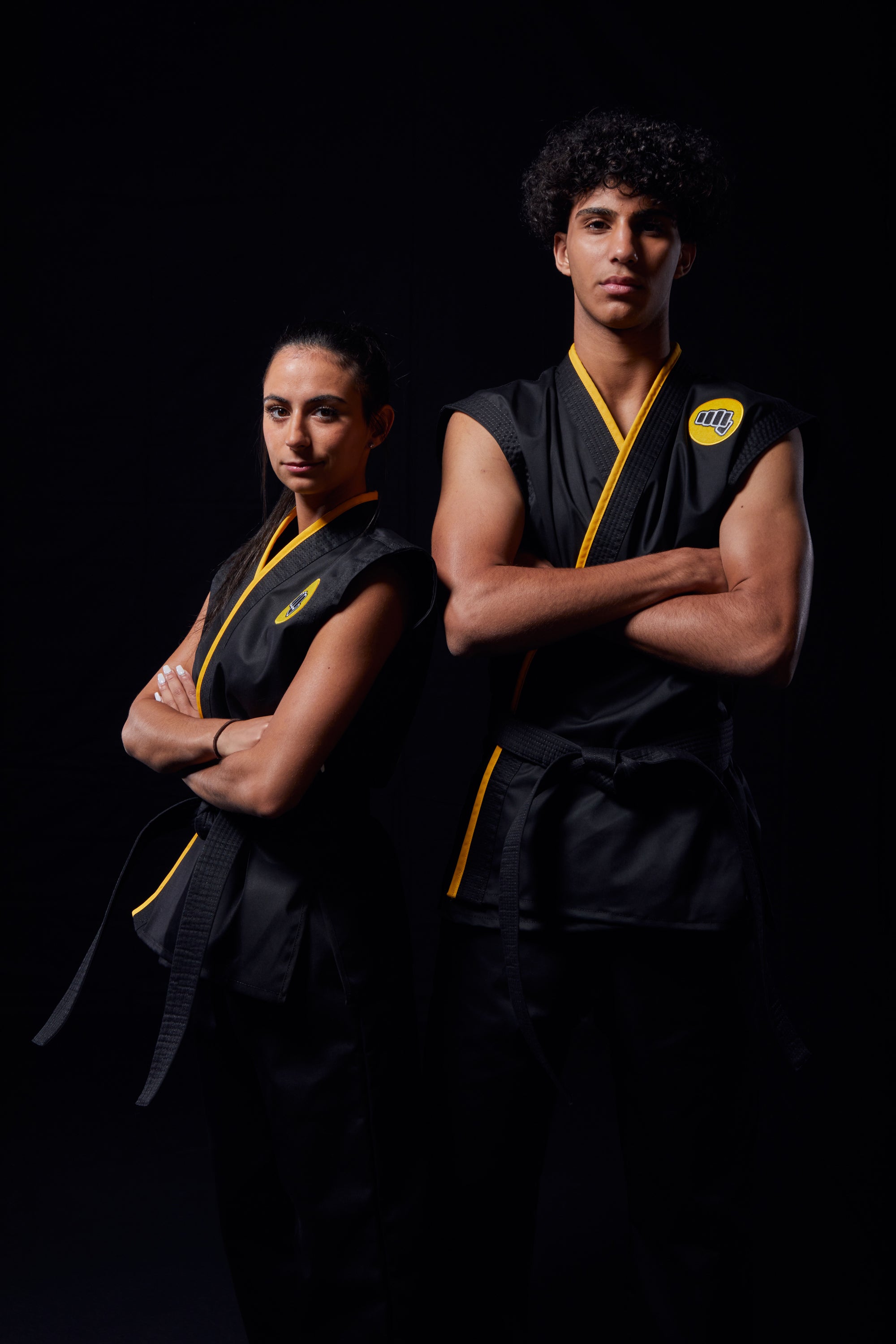 girl and boy wearing cobra kai uniform