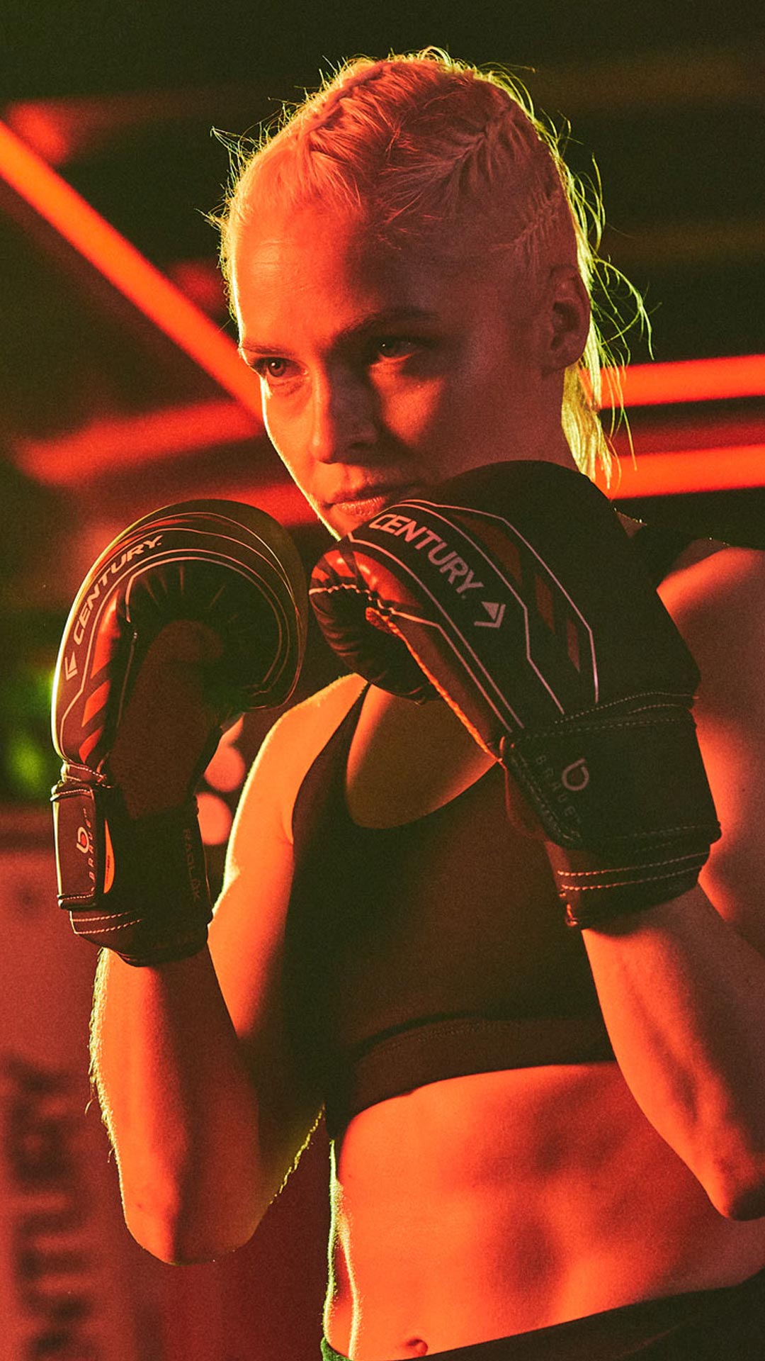 Woman in gym in Brave gloves