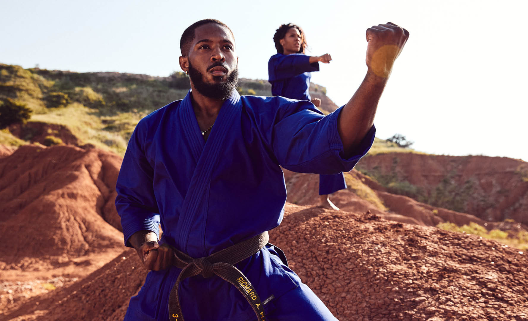 man and woman outdoors in century uniforms