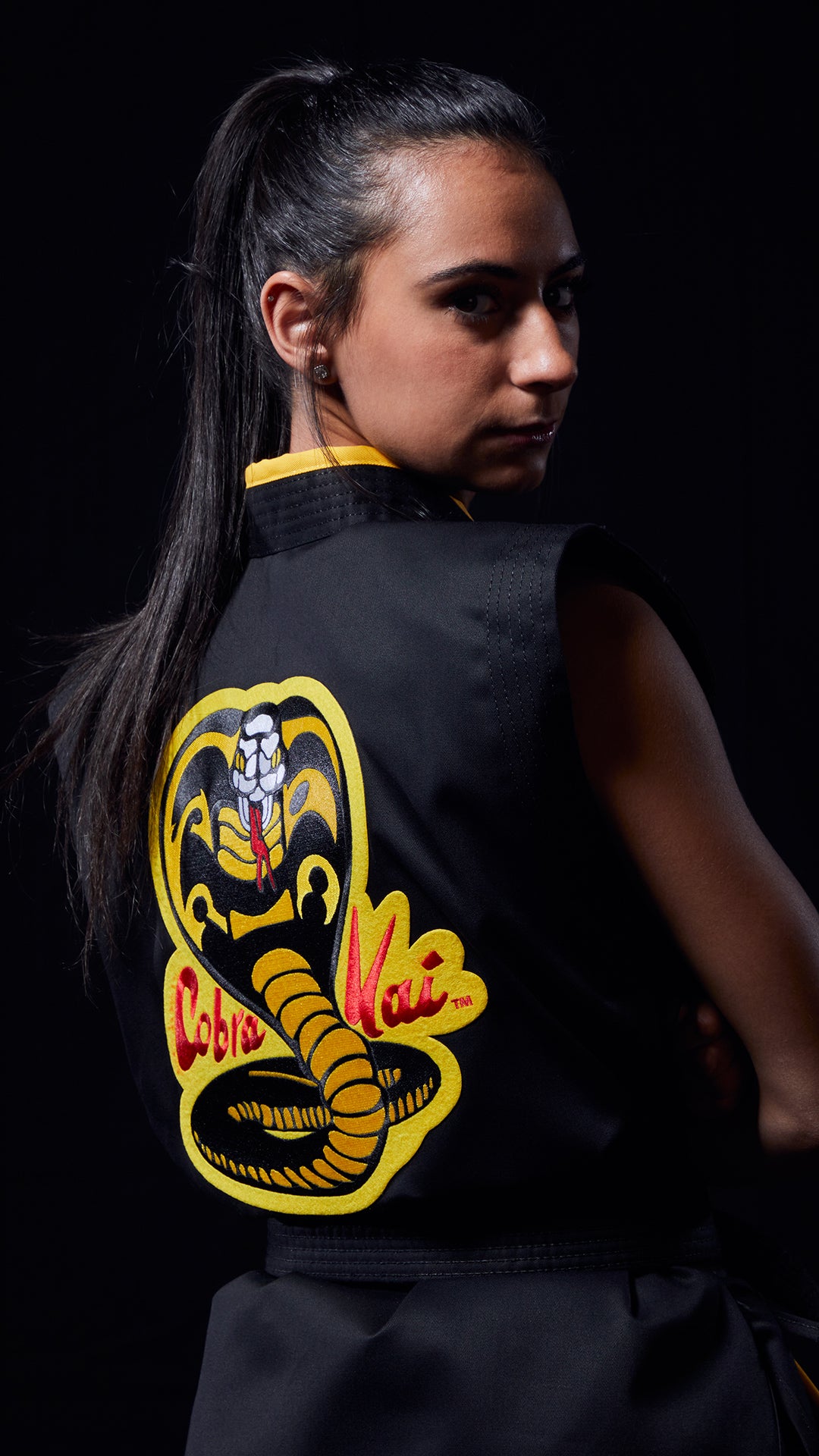 girl wearing cobra kai uniform
