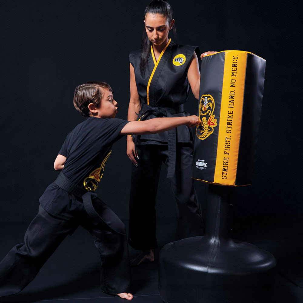 Girl and young boy training in cobra kai gear